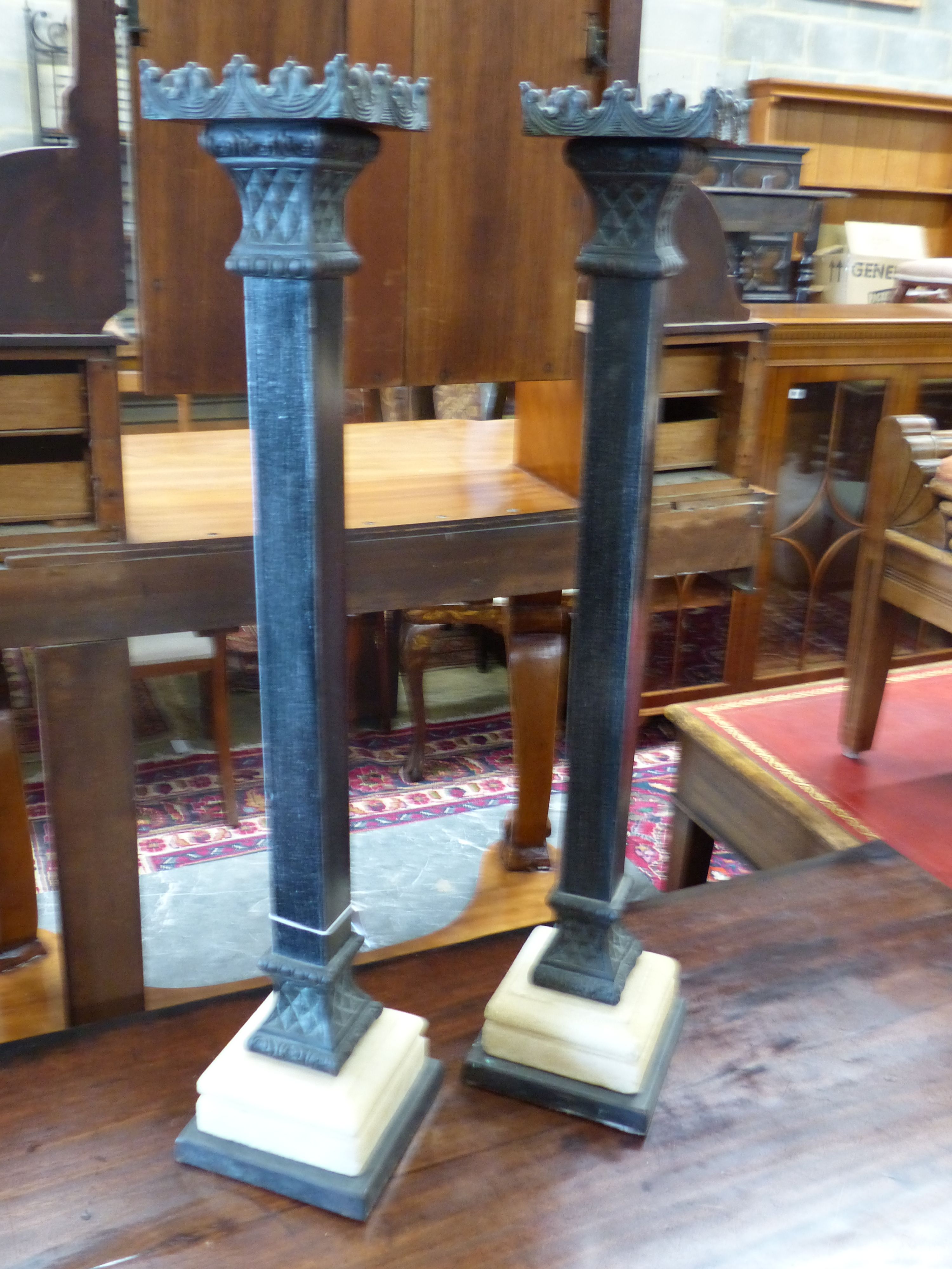 A pair of cast metal pricket candlesticks, height 67cm